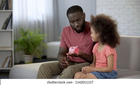 Father Giving Piggy Bank To Little Daughter, Teaching Child To Save Money