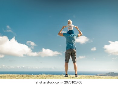 Father Giving Son A Piggy Back Ride Outdoors In The Park