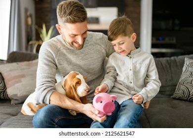 A Father or Godfather with Basset dog having fun on the living room At Home puting some money on piggy bank