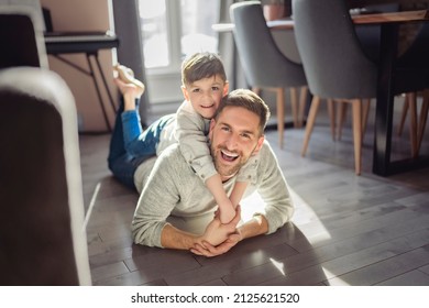 A Father or Godfather having fun on the apartment floor At Home