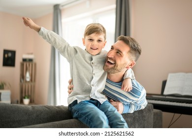 A Father Or Godfather Having Fun On The Living Room At Home