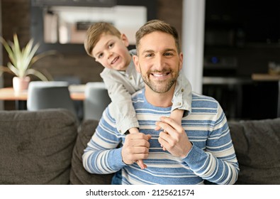 A Father Or Godfather Having Fun On The Living Room At Home