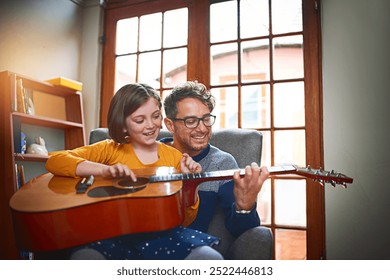 Father, guitar and girl in home for teaching, bonding and development with music, relax and playing. Dad, instrument and daughter in apartment for relationship, learning and hobby with fun lesson - Powered by Shutterstock