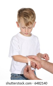 Father Hands Putting A Band Aid On His Little Son’s Arm