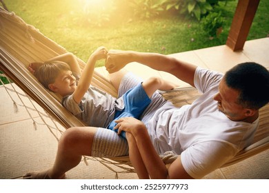 Father, happy and fist bump son by home for bonding, support and solidarity on hammock in backyard. Family, dad and boy by house outdoor for handshake, celebration and development with teamwork trust - Powered by Shutterstock