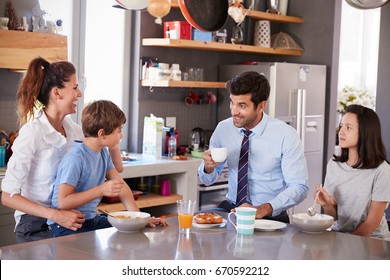 Father Having Family Breakfast In Kitchen Before Leaving For Work