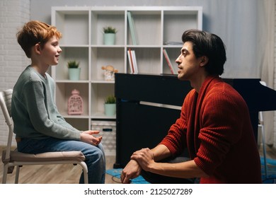 Father Having Serious Conversation With 8-year-old Son By Looking Him In Eye At Home. Loving Parent Dad Of Small Child Boy Giving Advice Psychological Support Express Trust. 