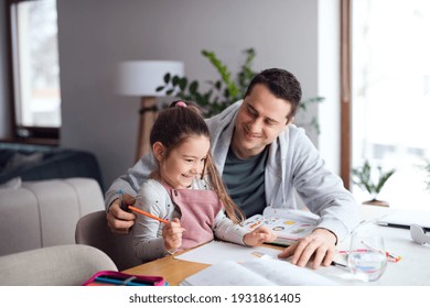 Father helping daugther with homework indoors at home, distance learning. - Powered by Shutterstock