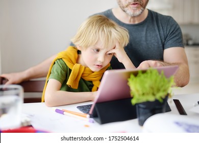 Father helping his child do homework at home.Tired child does not understand.Homeschooling, distance learning, online studying, remote education for kids during quarantine is problems for many parents - Shutterstock ID 1752504614