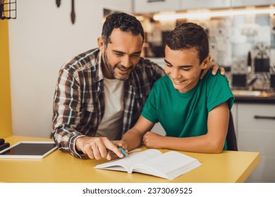 Father is helping his son with learning. They are doing homework together. - Powered by Shutterstock