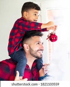 Father Helping His Son To Put Christmas Balls