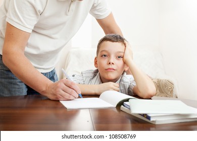 Father helping son do homework. Problems with homework - Powered by Shutterstock