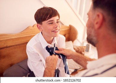 Father Helping Son To Tie Necktie Before He Leaves Home For First Day At High School - Powered by Shutterstock