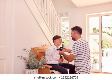 Father Helping Son To Tie Necktie Before He Leaves Home For First Day At High School - Powered by Shutterstock