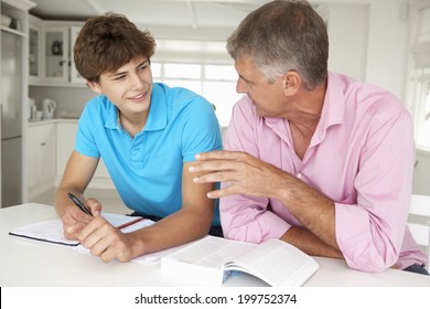 Father Helping Teenage Son With Homework