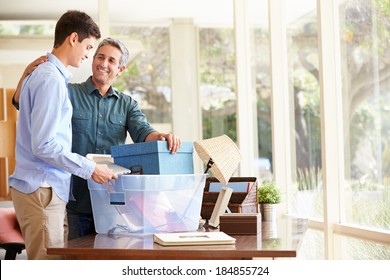 Father Helping Teenage Son Pack For College