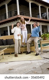 Father With His Children Playing Air Guitar On Patio