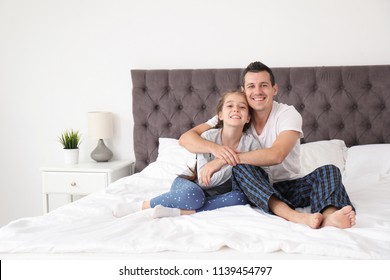 Father with his cute child in bedroom. Happy family