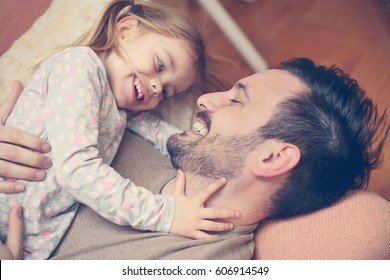 Father with his daughter spending time at home.
