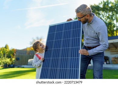 Father with his little daughter near their house with solar panels. Alternative energy, saving resources and sustainable lifestyle concept. - Powered by Shutterstock