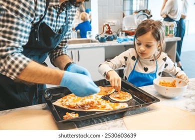 A father and his little daughter work together in a contemporary kitchen, putting ingredients onto a homemade pizza. The scene highlights the fun and bonding that comes with family cooking projects. - Powered by Shutterstock