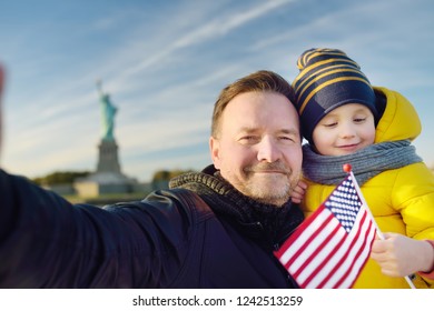 Father And His Little Son Take Selfie On The Background Of The Statue Of Liberty. The Concept Of Family Travel