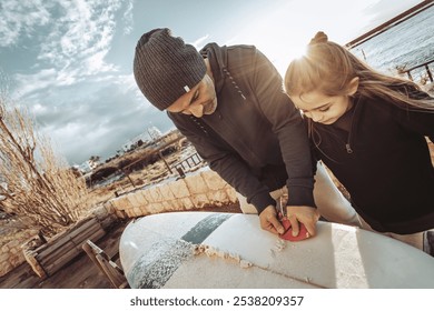 Father and His Son Enjoying a Surfboard Preparation Session by the Beach - Powered by Shutterstock