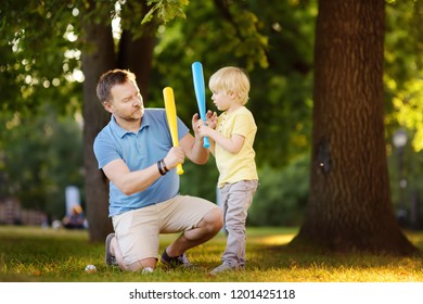 Father And His Son Playing Baseball In Park.Outdoor Sport Activities For Family With Kids.