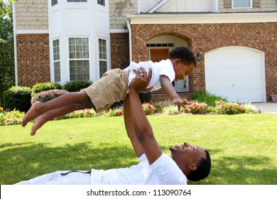 Father And His Son Playing Outside In Their Yard