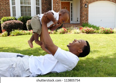 Father And His Son Playing Outside In Their Yard