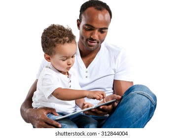 Father and his son reading fairy tale on tablet PC. Learning and early education concept / photos of Hispanic man and mixed race boy over white background
