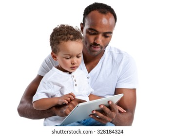 Father And His Son Reading Fairy Tale On Tablet PC. Learning And Early Education Concept / Photos Of Hispanic Man And Mixed Race Boy Over White Background