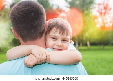 Father With His Son Walking Outdoor. Child Hugging Dad. Family Love Concept. Summer.