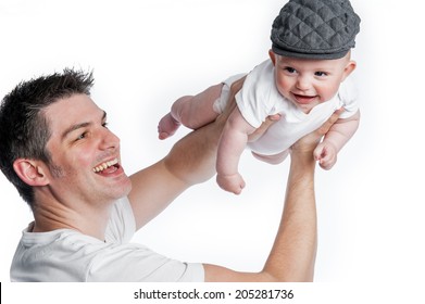 Father holding up baby son. Studio shot on white background.