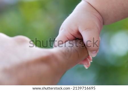 The father is holding the hand of the child. father's and child hands. Family concept 