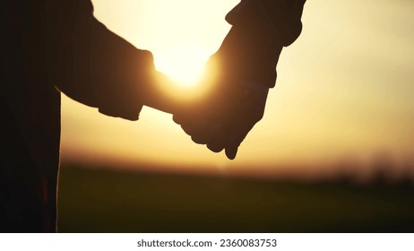 father holding her son hands. happy family kid dream concept. father take care her daughter holding her hands at sunset in the park close-up. hands close-up parent and lifestyle daughter - Powered by Shutterstock