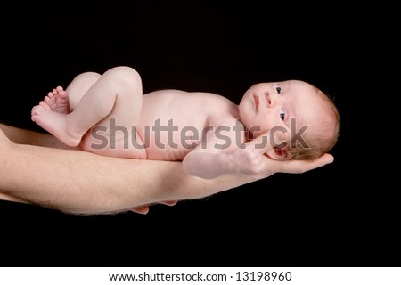 Father holding his 15 days old baby on his arm
