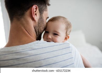 Father holding his baby girl at home - Powered by Shutterstock