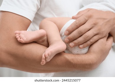 Father holding his cute baby, closeup view - Powered by Shutterstock