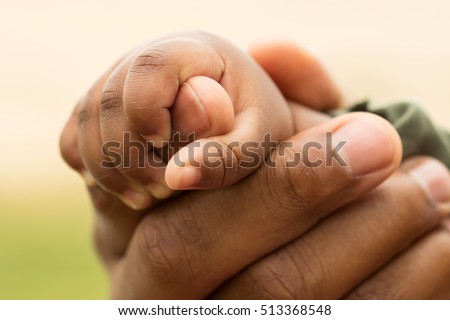 Father holding his daughter's hand.