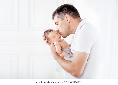 Father holding his newborn baby in  hands. Father kissing his baby - Shutterstock ID 1149085823