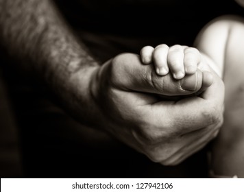 Father Holding His Son's Hand - Black And White Photography