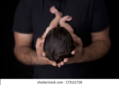 Father Holding Newborn Baby 