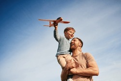 Father Is Holding Son That Playing With Toy Plane.
