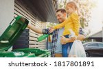 Father Holding a Young Girl and Throw Away an Empty Bottle and Food Waste into the Trash. They Use Correct Garbage Bins Because This Family is Sorting Waste and Helping the Environment.