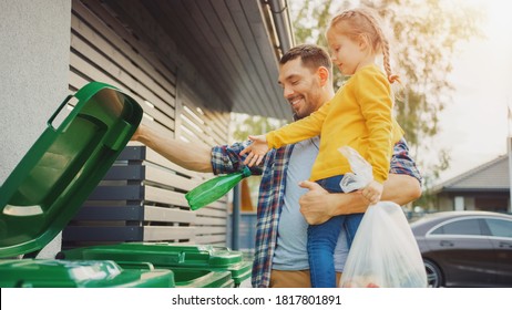 Father Holding a Young Girl and Throw Away an Empty Bottle and Food Waste into the Trash. They Use Correct Garbage Bins Because This Family is Sorting Waste and Helping the Environment.