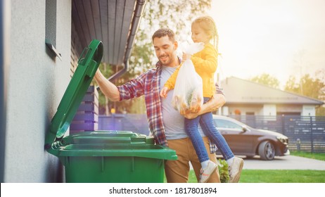 Father Holding a Young Girl and Throwing Away a Food Waste into the Trash. They Use Correct Garbage Bins Because This Family is Sorting Waste and Helping the Environment. - Shutterstock ID 1817801894