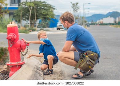 Father influence son worldview family education study everyday knowledge skills. Dad in blue COVID face mask show tell teach child fireman fighters engine use red fire hydrant. Children safety concept