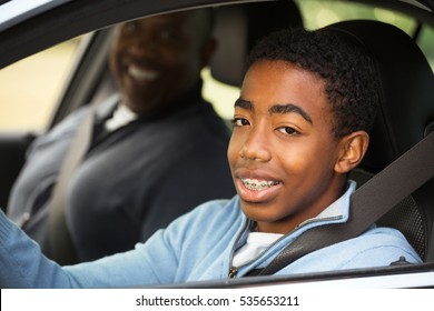 Father instructing his son on driving.