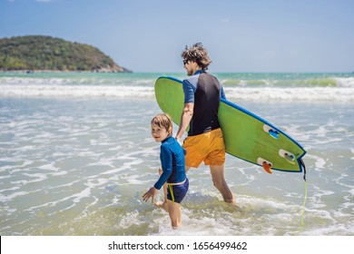 Father or instructor teaching his son how to surf in the sea on vacation or holiday. Travel and sports with children concept. Surfing lesson for kids - Powered by Shutterstock